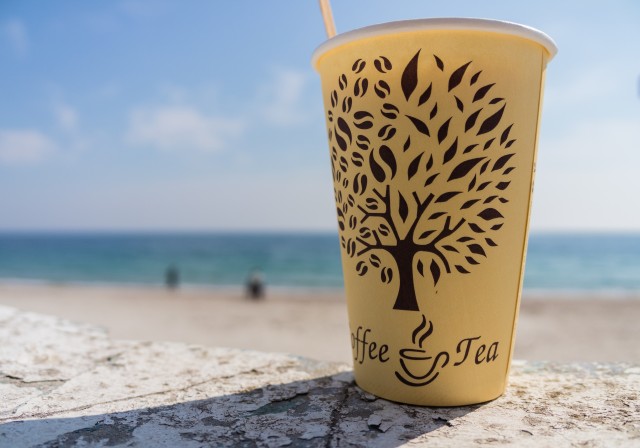 paper-cup-with-a-drink-on-the-beach-SBI-310340424.jpg
